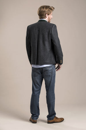 a backside view of a 30 year old man wearing an austrian loden wool jacket