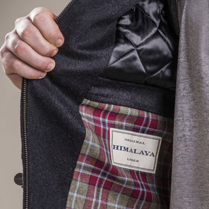 a close up view of the inside breast a 30 year old man wearing a duffel coat made from 100% austrian loden wool