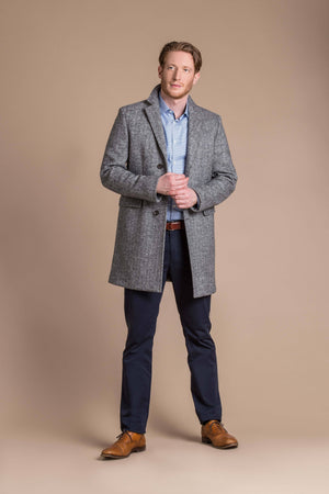 man wearing a Robert W. Stolz boiled wool herringbone weave overcoat
