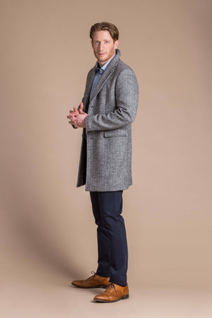 man wearing a Robert W. Stolz boiled wool herringbone weave overcoat