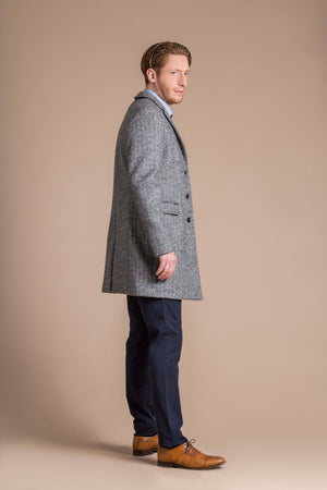 man wearing a Robert W. Stolz boiled wool herringbone weave overcoat