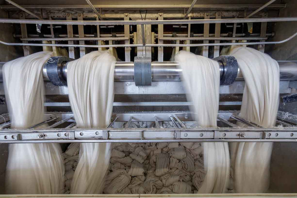 wool fabric going through a fulling machine in traditional bavarian mill.