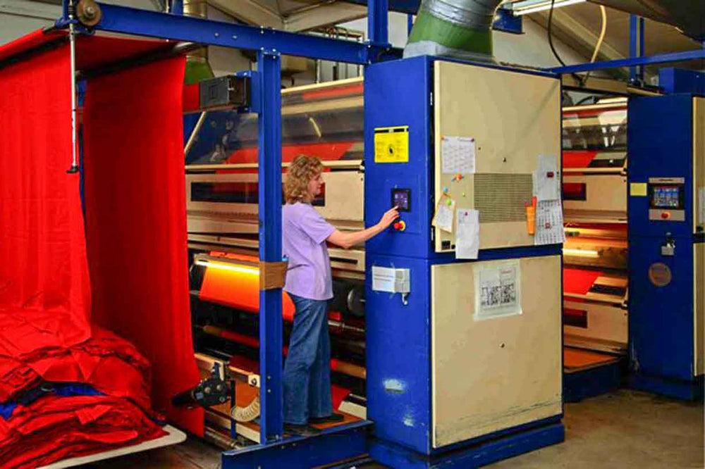 German woman operating finishing equipment in a bavarian mill