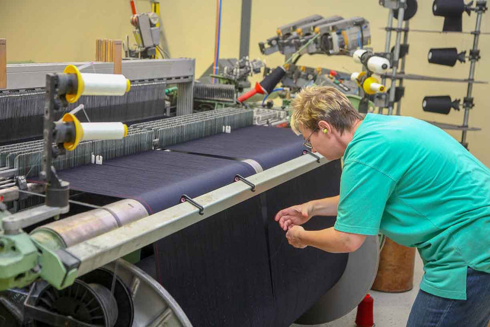 german woman preparing the loom in a bavarian woolen mill