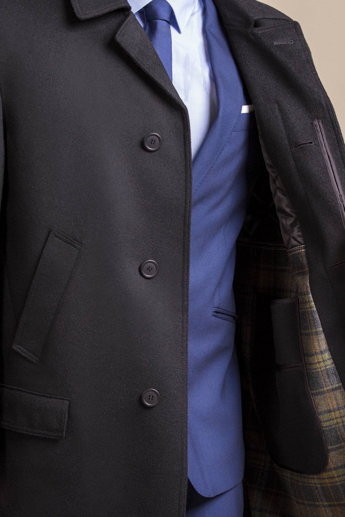 a close up view of a 30 year old man wearing an austrian himalaya loden wool overcoat