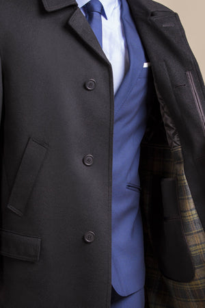 a close up view of a 30 year old man wearing an austrian himalaya loden wool overcoat