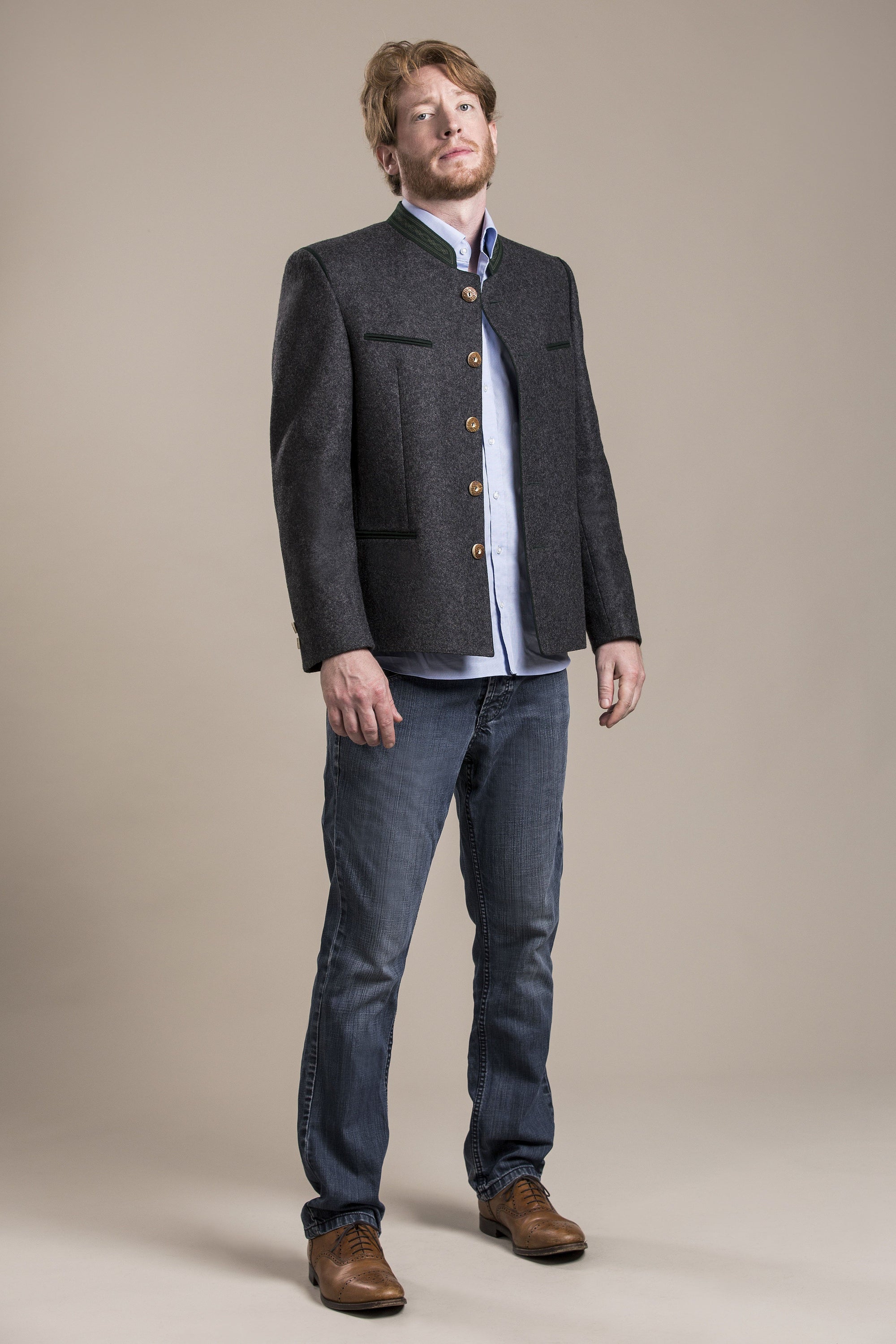 a front view of a 30 year old man wearing an austrian loden wool jacket