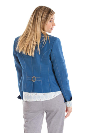 back view of a young blonde women wearing a blue Austrian linen riding jacket