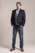 a frontal view of a 30 year old man wearing a wool blazer made from austrian himalya loden wool