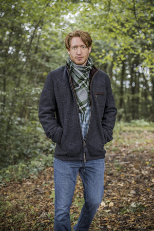 view of a 30 year old man wearing a contemporary austrian wool walk jacket with zipper in the forest