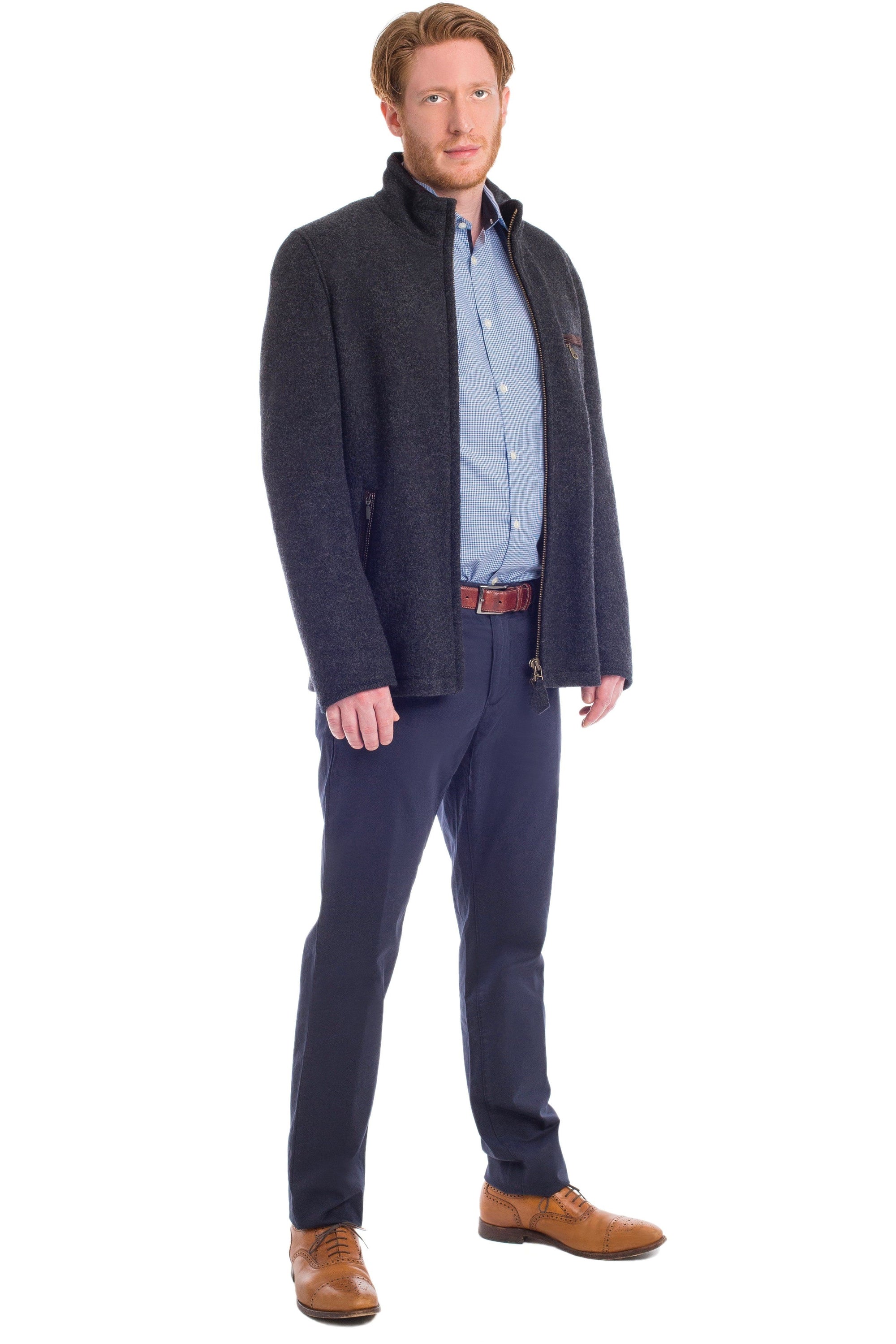 view of a 30 year old man wearing a contemporary austrian wool walk jacket with zipper in the forest