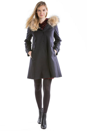 pretty blonde girl wearing a fur lined black loden coat