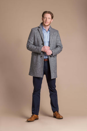 man wearing a Robert W. Stolz boiled wool herringbone weave overcoat 