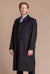 man wearing a black cashmere full length loden overcoat