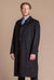man wearing a black cashmere full length loden overcoat